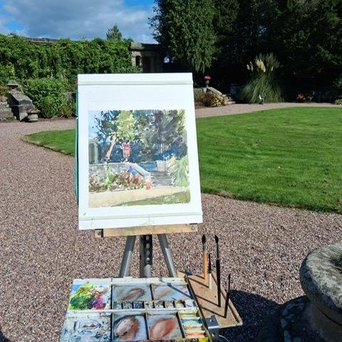 An easel with canvas and paints  in the garden of Bishton Hall.